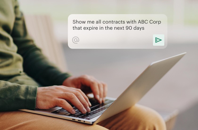 Man typing a prompt to AI Assistant to find all contracts that expire in 90 days